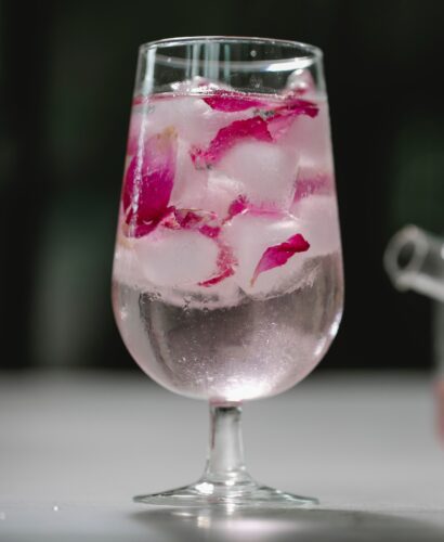 Glass of water with rose petals